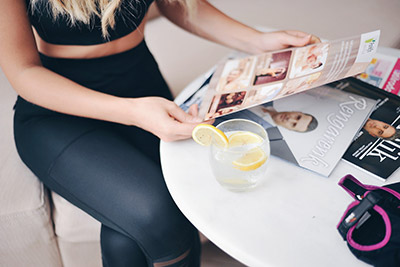 woman relaxing with drink and magazines - Photo by ŞULE MAKAROĞLU on Unsplash